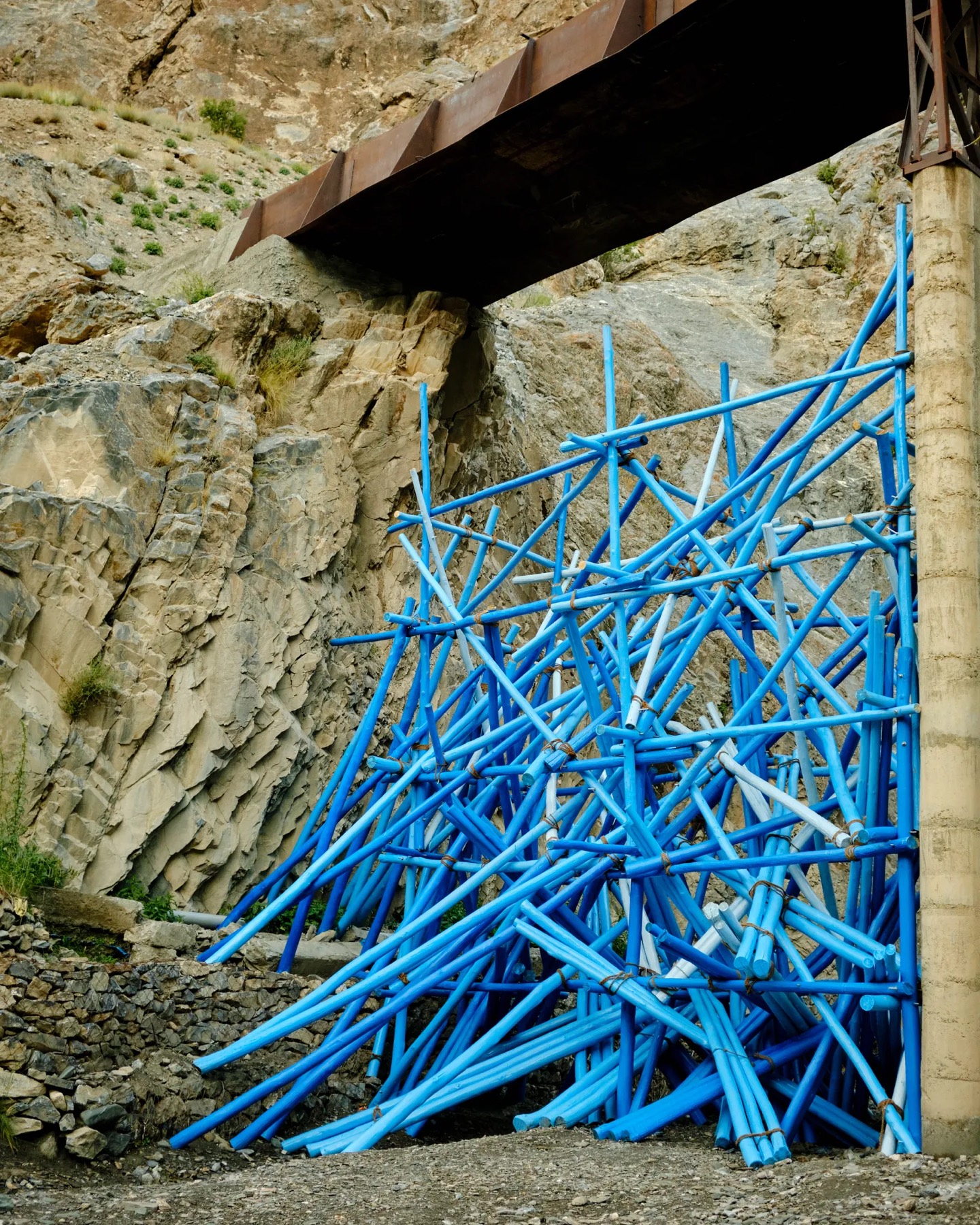 Blue bamboo installation on a cliff